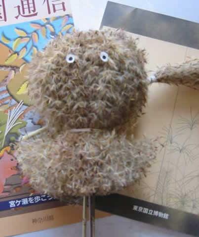 This owl is made from several flowers, stationery and fall brochures are shown in the background.